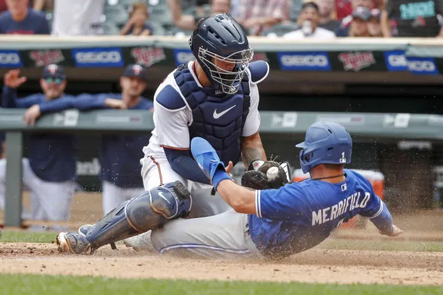 Minnesota Twins catcher Gary Sanchez tags out Toronto Blue Jays' Whit Merrifield who tags from third on a sacrifice fly by Cavan Biggio in the tenth inning of a baseball game Sunday, August 7, 2022, in Minneapolis. The play was overturned on review due to the catcher blocking the plate and the Blue Jays won 3-2 in 10. (Photo by Bruce Kluckhohn/AP Photo)
