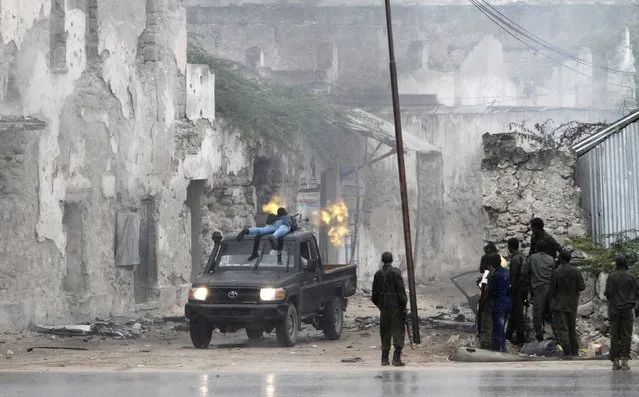 A Somali government soldier holds his fighting position against suspected militants during an attack at the Jilacow underground cell inside a national security compound in Mogadishu August 31, 2014. Islamist rebels blew up a car bomb and gunmen attacked the national-intelligence site in Somalia's capital where suspected militants are held, in an assault on Sunday that left 11 people dead, government officials and the rebel group said. (Photo by Feisal Omar/Reuters)