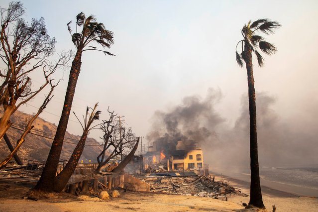 Smoke rises as the Palisades fire burns in Malibu during a windstorm on the west side of Los Angeles, on January 8, 2025. (Photo by Ringo Chiu/Reuters)
