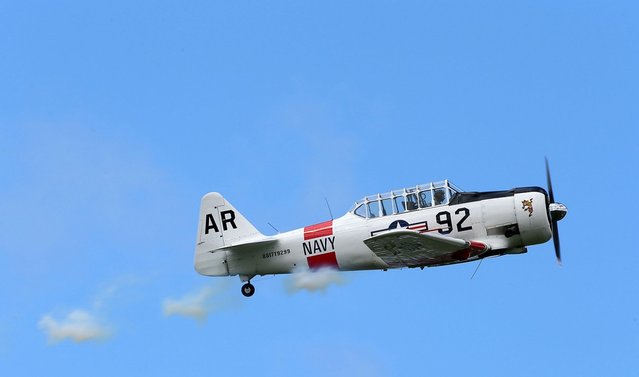 A pilot performs aerobatics in a vintage Harvard aircraft during an airshow commemorating the completion of the the rebuild of Havilland Mosquito KA 114, on September 29, 2012 in Ardmore, New Zealand. The plane was restored by Warbird Restorations at Ardmore Aerodrome and is the only flying Mosquito in the world.  (Photo by Simon Watts)