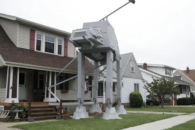 This Thursday, October 12, 2017 photo shows a replica four-legged All Terrain Armored Transport, or AT-AT walker in Parma, Ohio. Owner Nick Meyer tells Cleveland.com he used wood, hard foam and plastic barrels. He says he enjoys the “Star Wars” movies but isn't a fanatic and simply thought the display would be unique. (Photo by Patrick Cooley/The Plain Dealer-Cleveland.com via AP Photo)