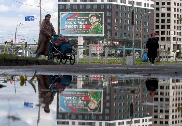 A billboard promoting contract army service with an image of a serviceman and the slogan reading “Serving Russia is a real job” sits in Saint Petersburg on September 20, 2022. (Photo by Olga Maltseva/AFP Photo)