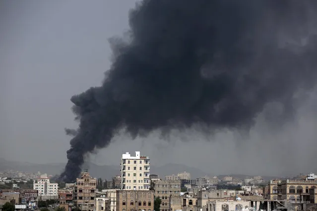 Smoke rises after Saudi-led airstrikes hit a food factory in Sanaa, Yemen, Tuesday, August 9, 2016. A Yemeni factory official and two medics say a Saudi-led airstrike has killed 14 civilians working on an overnight shift in the capital, Sanaa. They say the airstrikes were targeting Yemen's Shiite rebels in Sanaa but instead one of them hit a food factory. The heavy bombardment comes on the heels of the failed U.N. peace talks in Kuwait between Yemen's internationally-recognized government and the Shiite rebels known as Houthis. (Photo by Hani Mohammed/AP Photo)