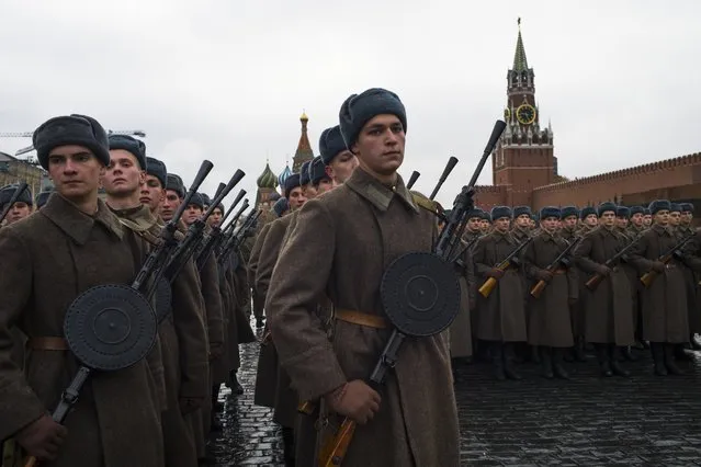 Russian soldiers dressed in Red Army World War II uniforms prepare to march during a rehearsal of a historical parade in Red Square, in Moscow, Russia, Sunday, November 5, 2017. The parade commemorates the participants in a Nov. 7, 1941 parade who headed directly to the front lines to defend Moscow from Nazi forces. (Photo by Alexander Zemlianichenko/AP Photo)