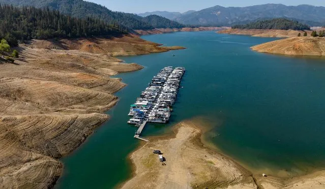 Boats are parked at a Shasta Lake marina in Lakehead, California on October 16, 2022. Shasta Lake currently sits at 32% of its capacity as drought conditions persist throughout the west. (Photo by Josh Edelson/AFP Photo)