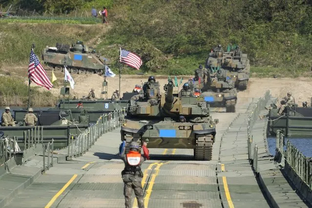 South Korean Army K2 tanks cross a floating bridge on the Namhan River during a joint river-crossing drill between South Korea and the United States in Yeoju, South Korea, Wednesday, October 19, 2022. (Photo by Lee Jin-man/AP Photo)