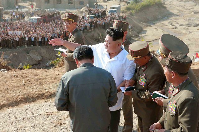 North Korean leader Kim Jong Un gives guidance on the field during the drive for recovery from the flood that hit Rason city in this undated picture. (Photo by Reuters/KCNA)