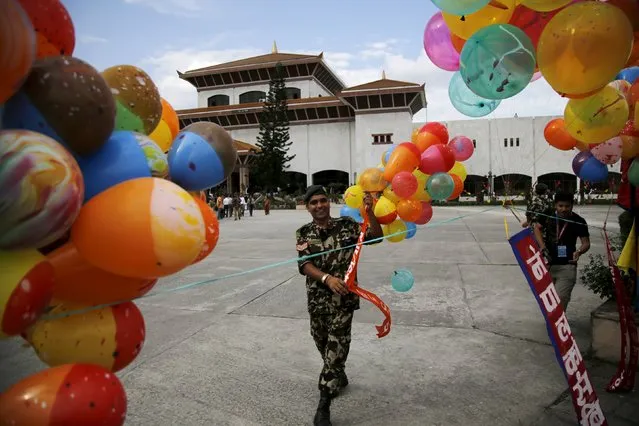 A Nepalese army personnel decorates the premises of the parliament before President Ram Baran Yadav formally promulgates the new constitution in Kathmandu, Nepal September 20, 2015. (Photo by Navesh Chitrakar/Reuters)