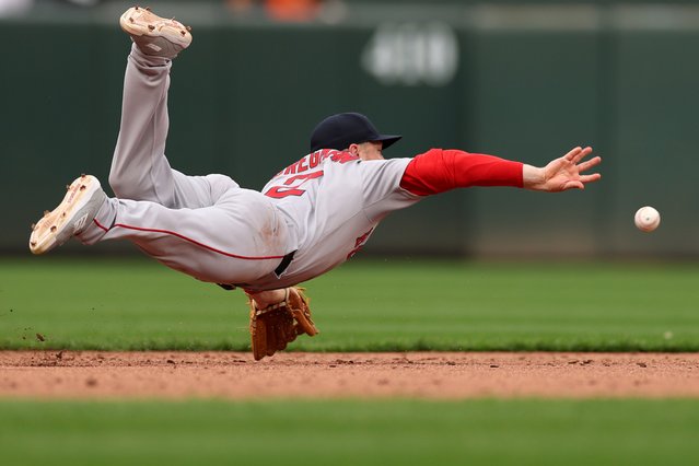 Alex Bregman #2 of the Boston Red Sox tries to make a play on a hit by the Baltimore Orioles in the eighth inning during their Opening Day game at Oriole Park at Camden Yards on March 31, 2025 in Baltimore, Maryland. (Photo by Patrick Smith/Getty Images)