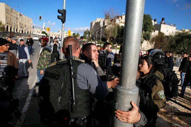A Palestinian man scuffles with an Israeli border policeman during a protest following U.S. President Donald Trump's announcement that he has recognized Jerusalem as Israel's capital, near Damascus Gate in Jerusalem's Old City December 7, 2017. (Photo by Ammar Awad/Reuters)