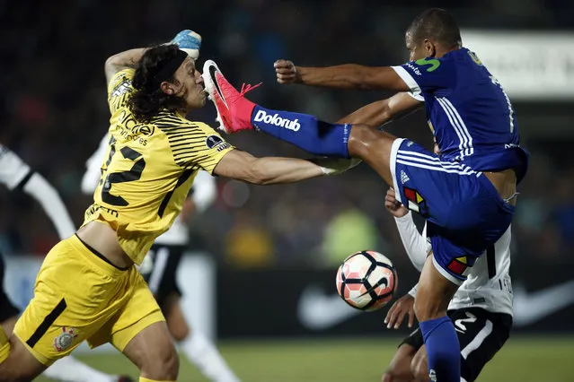 Cassio, goalkeeper of Brazil's Corinthians, left, fights for the ball with Leandro Benegas, of Universidad de Chile during a Copa Sudamericana soccer match in Santiago, Chile, Wednesday, May 10, 2017. (Photo by Luis Hidalgo/AP Photo)