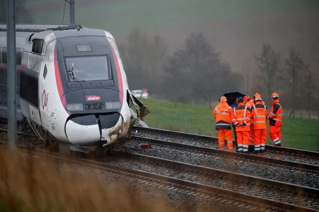 Employees work on the site of a derailed high-speed TGV train operated by state-owned railway company SNCF in Ingenheim, near Strasbourg, France, March 5, 2020. (Photo by Pascal Rossignol/Reuters)