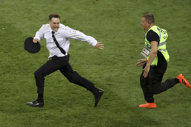 In this Sunday, July 15, 2018 file photo, Pyotr Verzilov invading the pitch, runs away as a steward tries to stop him during the France and Croatia 2018 World Cup final match in the Luzhniki Stadium in Moscow, Russia. Russian state news agency Tass says a prominent member of the protest group p*ssy Riot has been detained by the police anti-extremism division. The Mediazona website reported that Pyotr Verzilov was seized at his apartment by unidentified men who broke down the door on Sunday, June 21, 2020. (Photo by Thanassis Stavrakis/AP Photo/File)