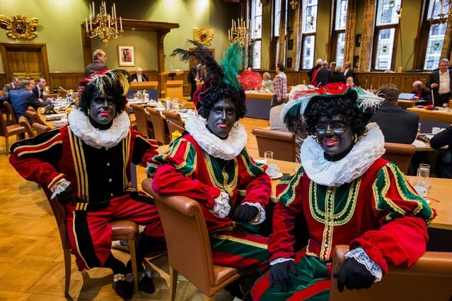 (L-R) Dutch right wing PVV State members Ton van Kesteren, Matthijs Jansen and Dennis Ram attend a meeting in the Province House in Groningen, The Netherlands, November 5, 2014, dressed as “Zwarte Piet” (Black Pete) to make a statement that according to them “Zwarte Piet” should not change his appearance in the city of Groningen during the Sinterklaas (Saint Nicolas) festival. (Photo by Vincent Jannink/EPA)