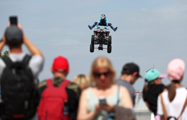 A motorcyclist performs during the Day of Moscow Sports Festival in Moscow, Russia, 31 May 2025. The festival, organized by Moscow authorities, aims to promote a healthy lifestyle. (Photo by Maxim Shipenkov/EPA/EFE)