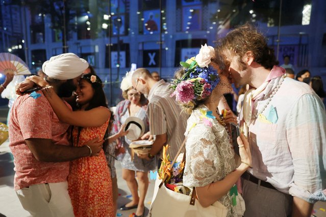 Couples kiss during “The Wedding: New York's Biggest Day”, an annual event that allows couples to celebrate their love at Lincoln Center in the Manhattan borough of New York City, U.S. June 21, 2025. (Photo by Heather Khalifa/Reuters)
