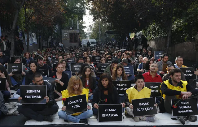 The students of Ankara University hold the placards with the names of those killed in Saturday's deadly explosions during a sit-in protest in Ankara, Turkey, Tuesday, October 13, 2015. Authorities in Istanbul banned a protest rally and march by the same trade union and civic society groups who lost friends and colleagues in Turkey's bloodiest terror attack. (Photo by Emrah Gurel/AP Photo)