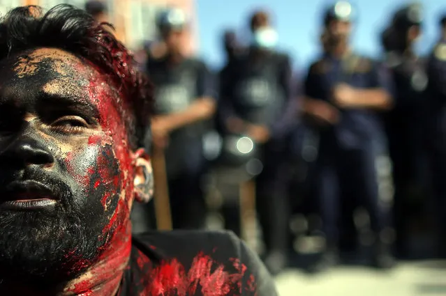 Artist belonging to Nepalese ethnic-based Madhesh political parties acts as an injured activist while protesting to mark the Nepal's first constitution day in Kathmandu, Nepal, 19 September 2016. Hundreds of members of Ethnic Madhesi political parties and related artists protest against the new constitution, which is celebrating by the government side on 19 September 2016. Madhesh based political parties say that this new constitution will not represent their demands which obstructs more political representation for ethnic minorities in the nation's parliament. (Photo by Narendra Shrestha/EPA)