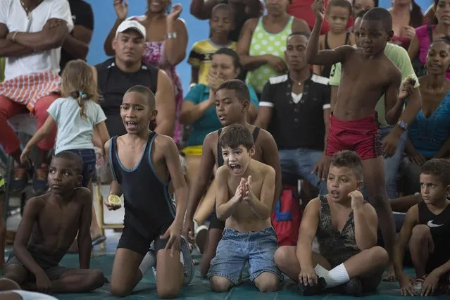 Children react during a local wrestling tournament in Havana, November 15, 2014. (Photo by Alexandre Meneghini/Reuters)