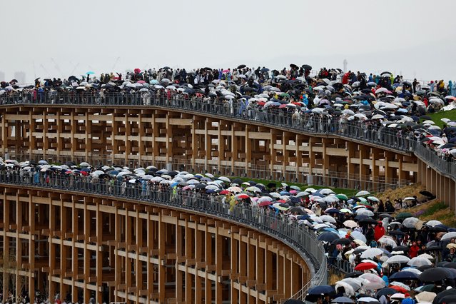 Visitors stand on the Grand Ring, the largest wooden architectural structure according to Guinness World Records, on Expo 2025's first day which is open to the public, in Osaka, western Japan on April 13, 2025. (Photo by Issei Kato/Reuters)