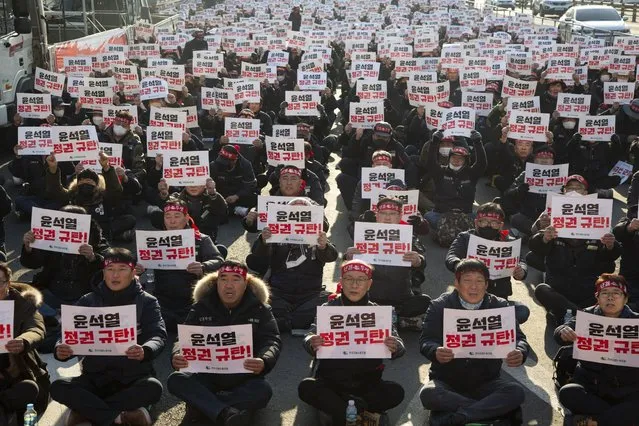 Members of Construction worker unions (KCWU) shout slogans and benners reading “Condemnation of the Regiem” during a rally against government's Labor Policy near the Presidential office in Seoul, South Korea, 11 January 2023. The protesters gathered to rally for labor reform and better working conditions. (Photo by Jeon Heon-Kyun/EPA/EFE/Rex Features/Shutterstock)