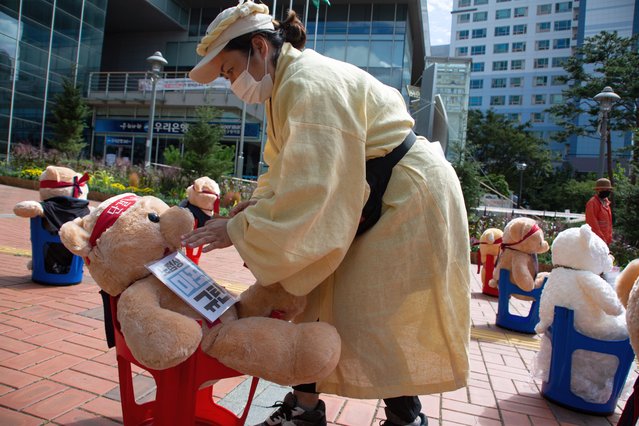 A member of the South Korean Confederation of Trade Unions (KCTU) wearing clothing associated with mourning takes part in a protest against government's labor policy, which uses dolls to mimic a labor strike portest, amid the COVID-19 pandemic lockdown in Seoul, South Korea, 24 September 2020. Seoul city government announced on 21 August an order that prohibits gatherings of more than ten people, as a precaution against the coronavirus pandemic. (Photo by Jeon Heon-Kyun/EPA/EFE)