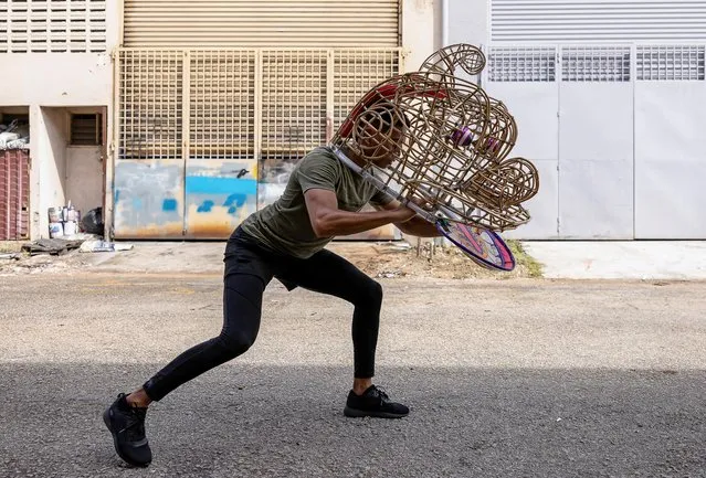 David, 29, a student from Reunion Island, France, practises with a lion dance head outside Wan Seng Hang Dragon and Lion Arts, a traditional workshop which produces about three to four hundred lion heads a year and is one of the handful remaining in the country, in Subang, Selangor, Malaysia on January 14, 2023. (Photo by Annice Lyn/Reuters)