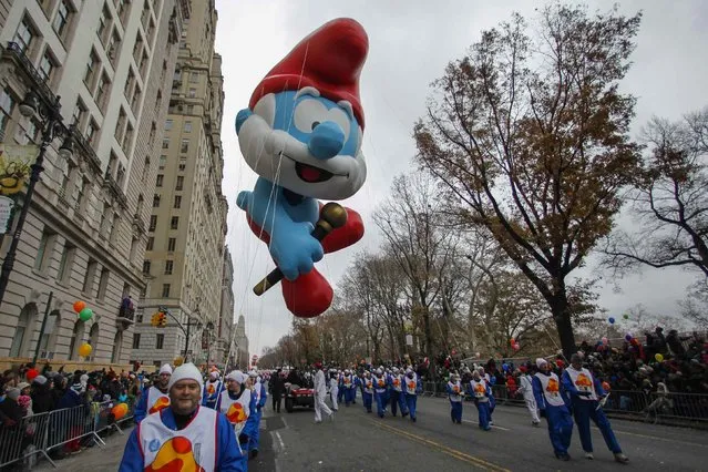 The Papa Smurf balloon floats down Central Park West during the 88th Macy's Thanksgiving Day Parade in New York November 27, 2014. (Photo by Eduardo Munoz/Reuters)