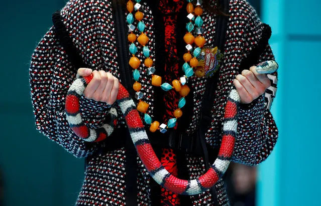 A model holds a snake as she presents a creation from the Gucci Autumn/Winter 2018 women collection during Milan Fashion Week in Milan, Italy February 21, 2018. (Photo by Tony Gentile/Reuters)