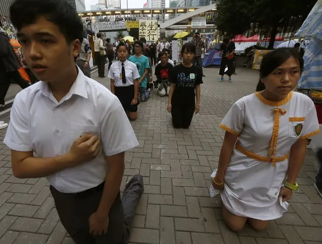 Secondary school students perform a barefoot “pilgrimage of suffering” to support the Occupy Central civil disobedience movement at the Admiralty protest site in Hong Kong November 30, 2014. It has been two months since police first fired tear gas to disperse demonstrators from the main protest site in the Admiralty district next to government offices in the heart of the Asian financial centre. (Photo by Bobby Yip/Reuters)