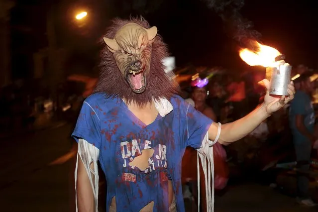 A reveller takes part in the popular annual Aguizotes festival in the indigenous community of Monimbo in Masaya, Nicaragua, October 23, 2015. During the festival, residents dress up in costumes of ghosts and other spirits of the dead from Nicaraguan myths and legends. (Photo by Oswaldo Rivas/Reuters)