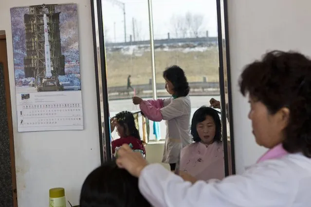 A 2013 calendar, showing a picture of North Korea's Unha-3 rocket, hangs inside a hair salon in Pyongyang, North Korea on Wednesday, February 20, 2013. (Photo by David Guttenfelder/AP Photo)