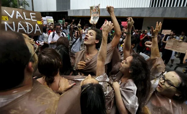Environmental activists chant slogans during a protest in front of the headquarters of Brazilian mining company Vale SA in downtown Rio de Janeiro, Brazil, November 16, 2015. (Photo by Sergio Moraes/Reuters)