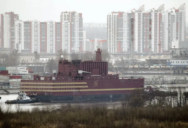 The floating nuclear power plant, the “Akademik Lomonosov”, is towed out of the St. Petersburg shipyard where it was constructed in St.Petersburg, Russia, Saturday, April 28, 2018. The “Akademik Lomonosov” is to be loaded with nuclear fuel in Murmansk, then towed to position in the Far East in 2019. (Photo by Dmitri Lovetsky/AP Photo)