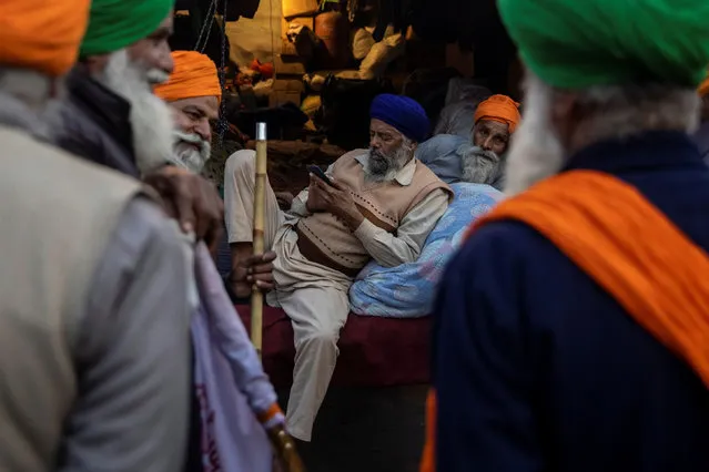 Farmers talk during a protest against the newly passed farm bills at Singhu border near Delhi, India, December 3, 2020. (Photo by Danish Siddiqui/Reuters)