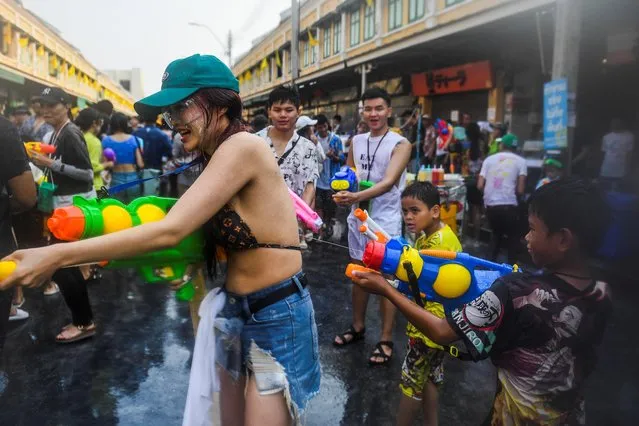 Locals and tourists play with water as they celebrate the Songkran holiday which marks the Thai New Year in Bangkok, Thailand on April 13, 2023. (Photo by Chalinee Thirasupa/Reuters)