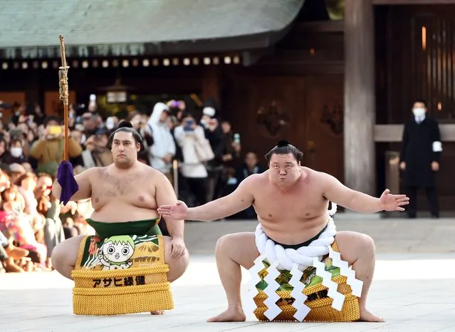Mongolian-born sumo grand champion, or “yokozuna”, Hakuho (R) performs a ring-entering ceremony beside Tsuyuharai Kaisei (L) at Meiji Shrine in Tokyo on January 7, 2015. Three sumo grand champions Hakuho, Kakuryu and Harumafuji, as well as Sumo Association leaders, made their New Year pilgrimage to the shrine on January 7, pledging to work hard to make Japan's national sport a success this year. (Photo by Toshifumi Kitamura/AFP Photo)
