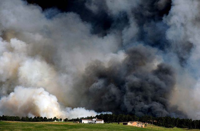 Large plumes of smoke rise from a wildfire in the Black Forest northeast of Colorado Springs, June 11, 2013. The fire is one of at least three significant wildfires burning in Colorado amid gusty winds and record-breaking hot, dry weather. (Photo by Helen H. Richardson/The Denver Post)