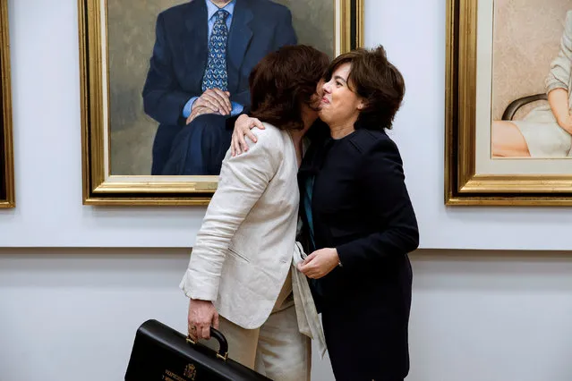 Spain's new deputy prime minister Carmen Calvo embraces former deputy prime minister Soraya Saenz de Santamaria during a handover ceremony at the Moncloa Palace in Madrid, June 7, 2018. (Photo by Luca Pergiovanni/Reuters/Pool)