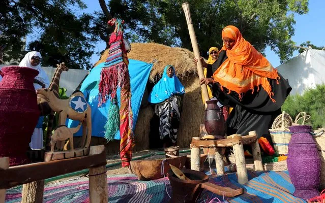 A Somali woman displays traditional items and prepares food during an event to showcase traditional Somali culture in Hamarweyne district in the capital Mogadishu, December 3, 2015. (Photo by Feisal Omar/Reuters)