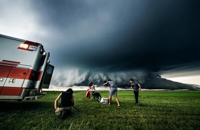 Benjamin Von Wong's surreal scenes include individuals ironing, barbequing, playing video games and even sitting on the toilet – seemingly unaware of the threatening situations approaching. (Photo by Anna Tenne/Caters News)