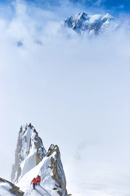 “Mont Blanc – the Queen of the Alps”. The south face of Mont Blanc is counted among the top 10 most dangerous climbs in Europe. On the photograph, dramatic clouds reveal the very summit of Mont Blanc with its numerous ice seracs. In the bottom part of the photograph we can see a pair of mountaineers traversing the ridge of Aiguille Marbrees, above the town of Courmayeur, Aosta, Italy. (Photo and caption by Kamil Tamiola/National Geographic Traveler Photo Contest)