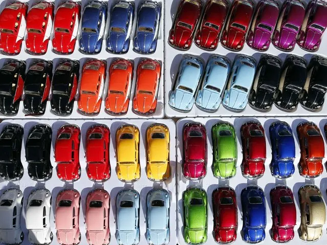 Miniature models of Volkswagen beetle are displayed during a Volkswagen Beetle owners meeting in Sao Bernardo do Campo January 25, 2015. (Photo by Paulo Whitaker/Reuters)