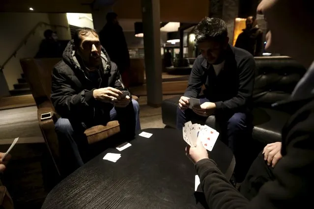 Refugees play cards in the lobby of their camp at a hotel touted as the world's most northerly ski resort in Riksgransen, Sweden, December 15, 2015. (Photo by Ints Kalnins/Reuters)