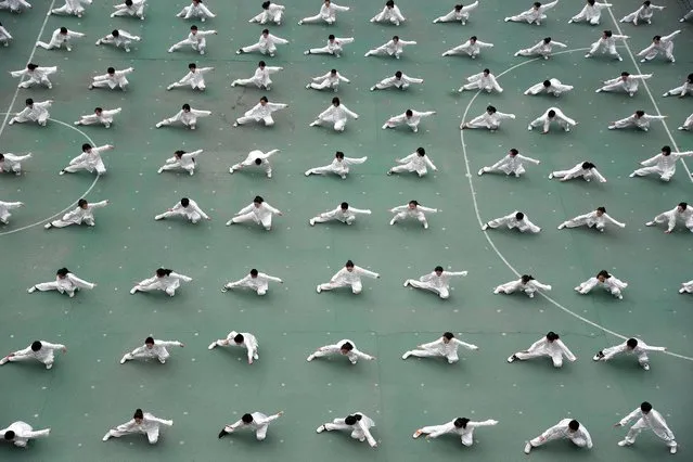 Aerial view of students practicing Tai Chi at a primary school on March 10, 2021 in Handan, Hebei Province of China. (Photo by Hao Qunying/VCG via Getty Images)