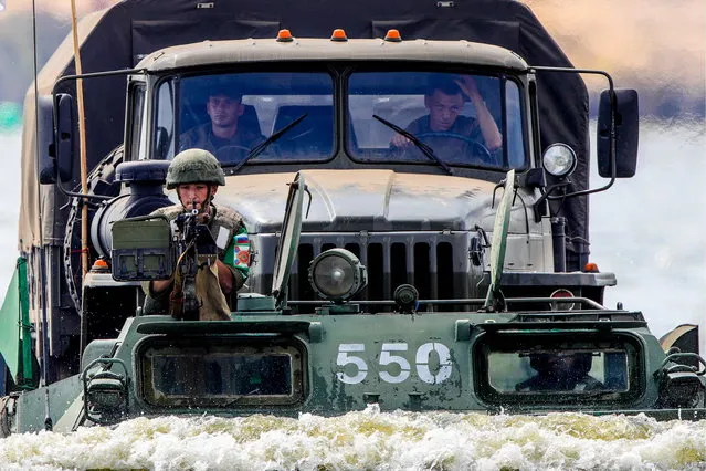 A Russian military truck on a PTS-2 amphibian during the Open Water contest between pontoon bridge units at the 2018 International Army Games on the Oka River, Vladimir Region, Russia, August 3, 2018. (Photo by Sergei Bobylev/TASS via Getty Images)