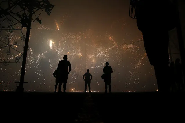 Enthusiasts watch a mechanised ground fireworks display during week-long celebrations marking the feast of the Assumption of Our Lady in Mosta, Malta on August 15, 2018. (Photo by Darrin Zammit Lupi/Reuters)