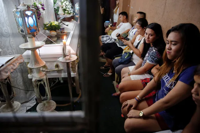 Friends and relatives mourn by the coffin during the wake for Florjohn Cruz, who was killed in a police drugs buy-bust operation, in Manila, Philippines late October 20, 2016. (Photo by Damir Sagolj/Reuters)