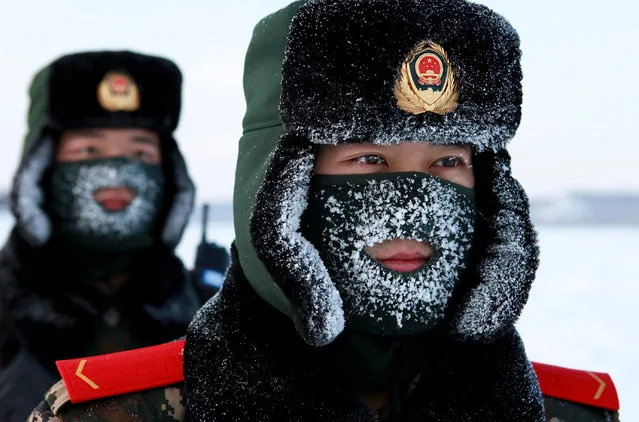 Chinese paramilitary police border guards train in the snow at Mohe County in China's northeast Heilongjiang province, on the border with Russia,  on December 12, 2016. Mohe is the northernmost point in China, with a sub arctic climate where border guards operate in temperatures as low as -36 Celcius. (Photo by AFP Photo/Stringer)