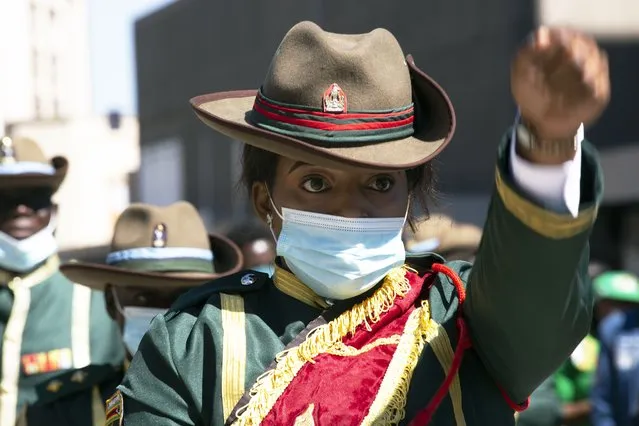 A member of the presidential guard marches during the unveiling of the statue of Charwe Nyakasikana in Harare, Tuesday, May, 25, 2021. Zimbabwe’s president vowed to ensure the repatriation of the skull of a 19th-century anti-colonialist heroine who was hanged for leading resistance to white occupation, as he unveiled her bronze statue. Nehanda Charwe Nyakasikana, more widely known as Mbuya (grandmother in Shona) Nehanda, was hanged in 1898 for leading an anti–colonial rebellion. (Photo by Tsvangirayi Mukwazhi/AP Photo)